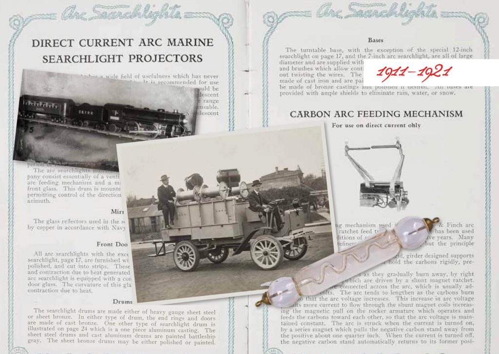 Carlisle and Finch Co. black and white photograph of car and train on searchlight advertisement from 1911 - 1921
